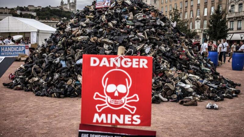 A pile of shoes during the annual demonstration by NGO Humanity and Inclusion denouncing antipersonnel landmines and cluster munitions in Lyon on September 20, 2014. © 2014 Getty Images